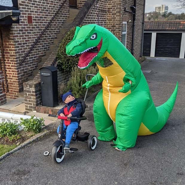 Fundraiser dressed in a dinosaur costume with her son