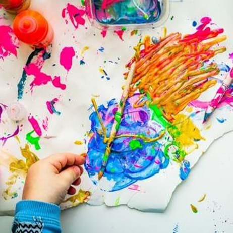 child with colourful paint