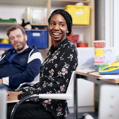 three trainee counsellors sitting at desk in training room