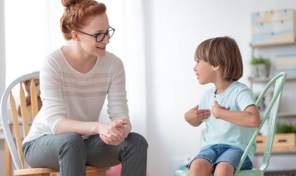 Woman and young child sitting on chairs having a conversation