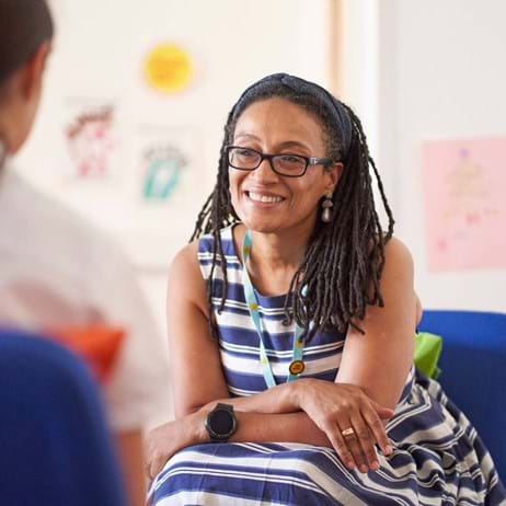 child counsellor sat with school pupil in Place2Be therapy room