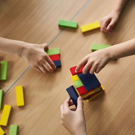 Children's hands playing game with building blocks