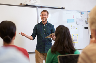 Male teacher teaching class of university students