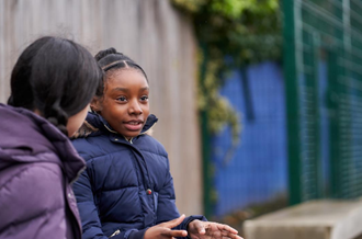 Two girls talking in playground