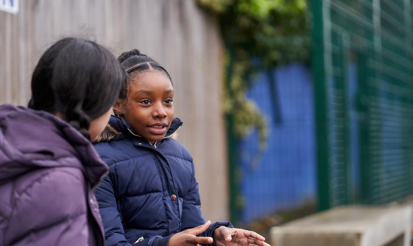 Two girls talking in playground