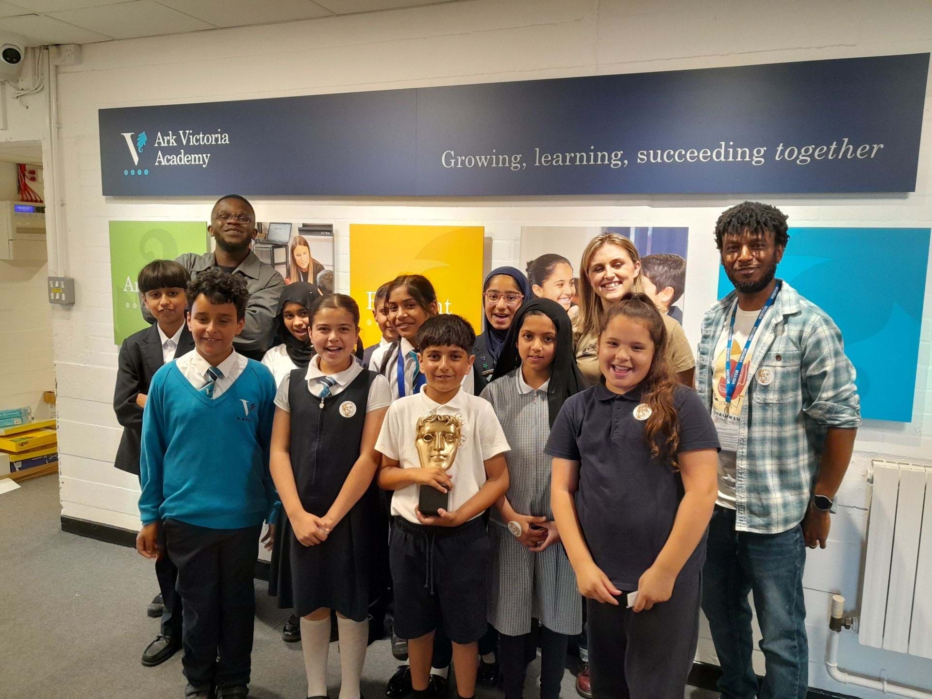 Students holding a BAFTA award with BAFTA guests