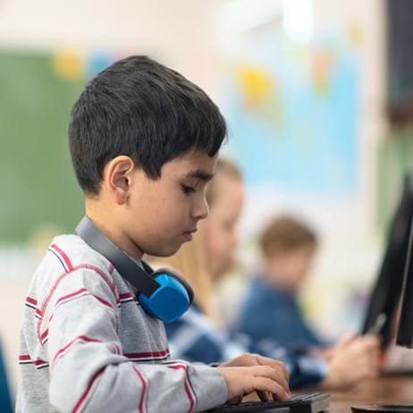 Boy typing at computer