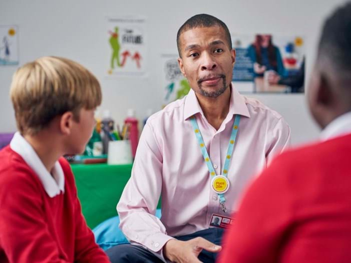 counsellor sat with two school pupils