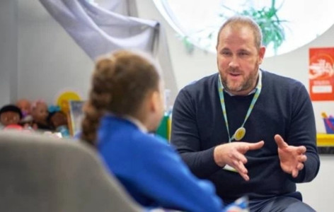 A child counsellor talking to school pupil in therapy room