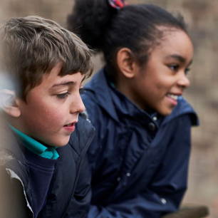 School boy and school girl smiling in playground