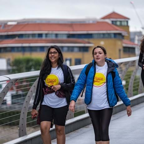 Two ladies walking on bridge