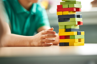 Child playing with jenga blocks