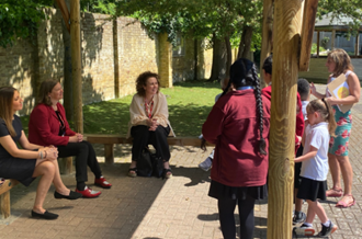 Pupils speaking to Dr Rosena, Fleur and Catherine Roche in the school playground