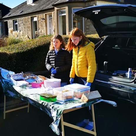 Grace and Lilly by a cake sale stand