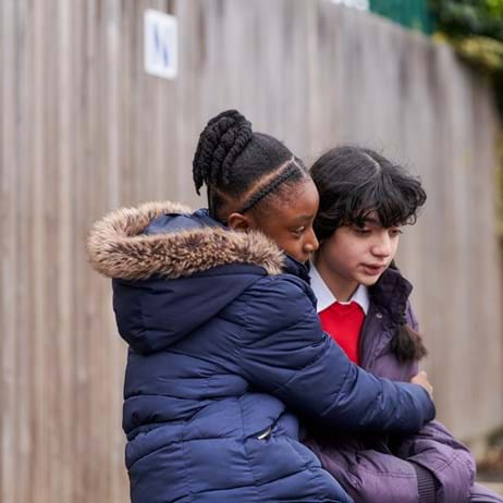 Children hugging in playground