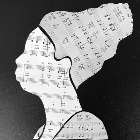 Artwork of music sheets in the shape of a head
