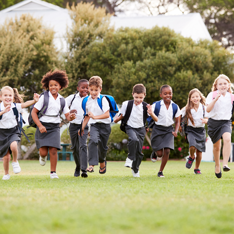 School children running on grass