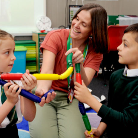 Counsellor playing with toys with school children