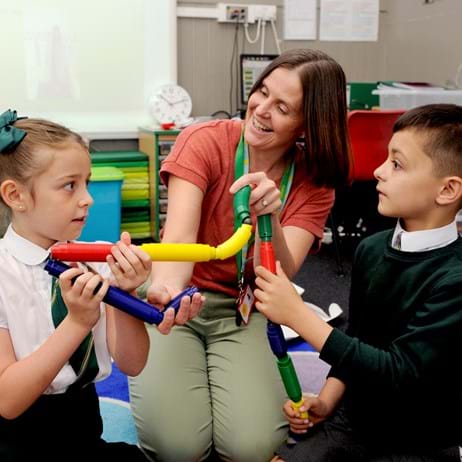 Children playing with toys with counsellor