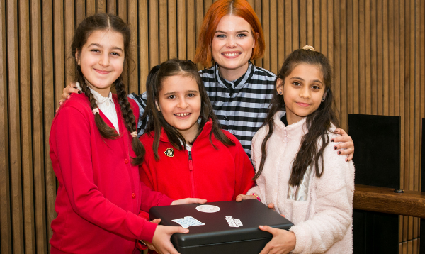 Three pupils from Upton Cross Primary School, and Lindsey Russell, holding the time capsule