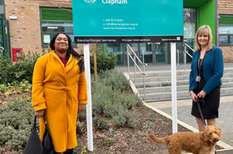 Streatham MP, Bell Ribeiro-Addy MP with Principal Gizle Landman and dog Mabel outside the school gate