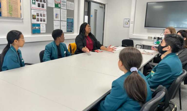 Streatham MP, Bell Ribeiro-Addy MP sitting in classroom talking with school council pupils