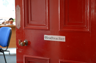Open door with 'Headteacher' plaque