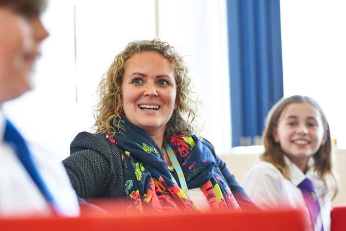 clinical supervisor sitting with two school pupils