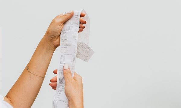 Hands holding long receipt