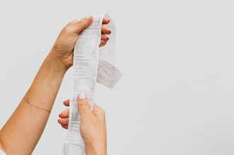 Female hands holding a long receipt