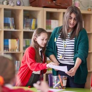 school counellor talking to young people in library