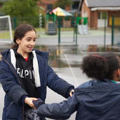 Children playing in wet school playground