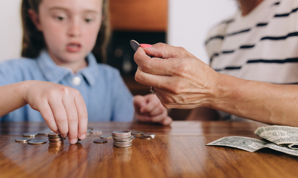 Adult and child counting coins and money