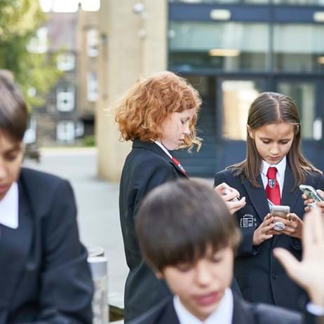 Young people on mobile phones in playground