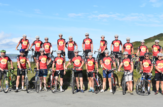 Head teachers with Place2Be tops on with their bikes for challenge event