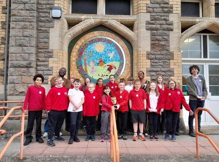 Moorland Primary School children posing with the BAFTA mask