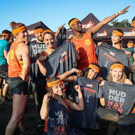 A group of fundraisers in Place2Be attire after taking on Tough Mudder