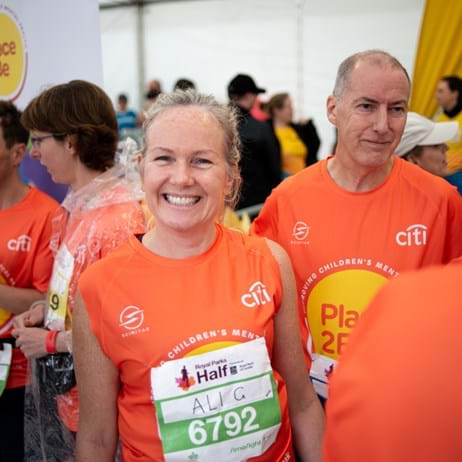 Woman smiling wearing Place2Be running shirt