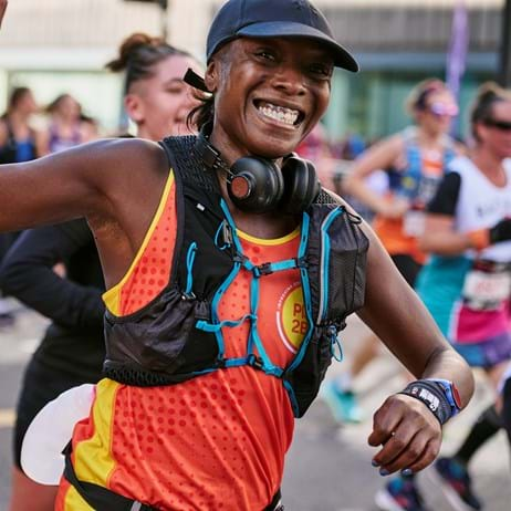 lady in Place2Be running vest running a marathon to fundraise for Place2Be