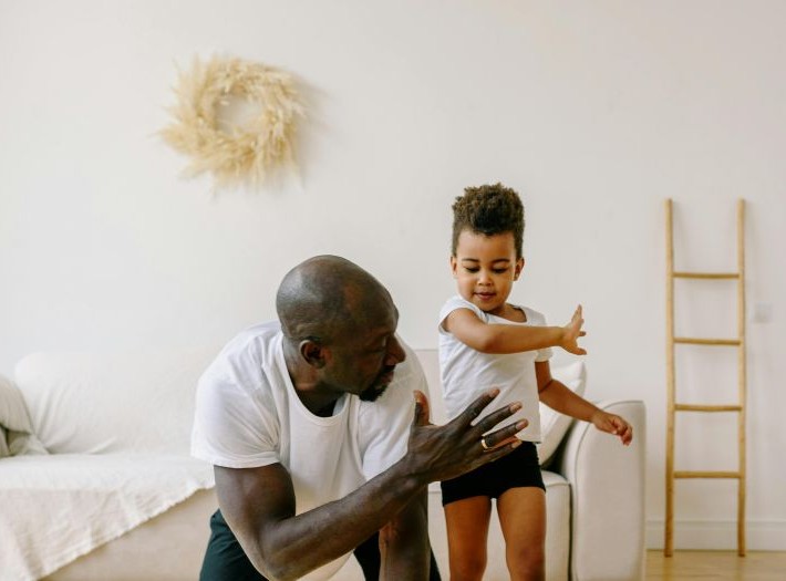 A father playing with their child