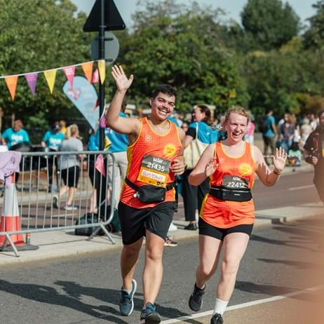 Happy runners waving