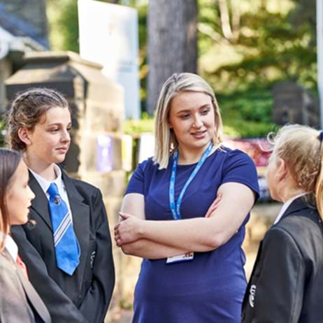 Pupils and schools staff chatting outside school