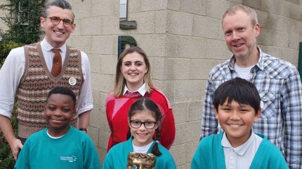 BAFTA Roadshow hosts Ben Shires (left) and Kia Pegg (centre), and guest speaker from Moonbug Entertainment Dan Balaam standing with Churchfield Primary School students. 