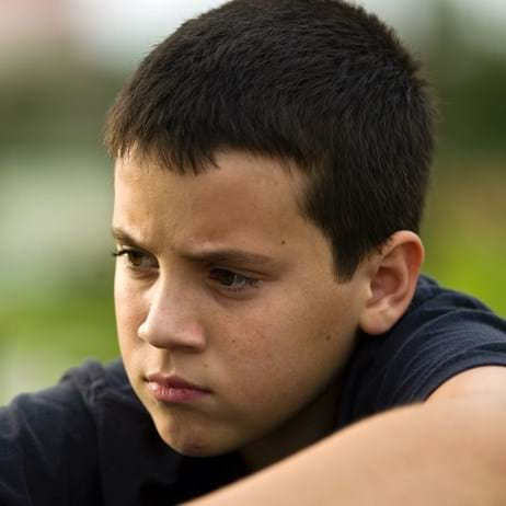 Boy outside looking sad