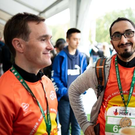 Runners smiling and talking after a fundraising race