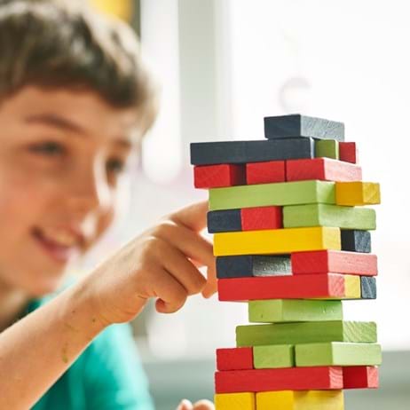Boy playing Jenga - mental health support in school
