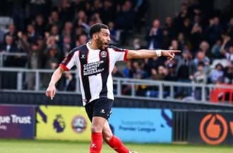 Brendan Kiernan, a professional footballer, in a match pointing at something off camera