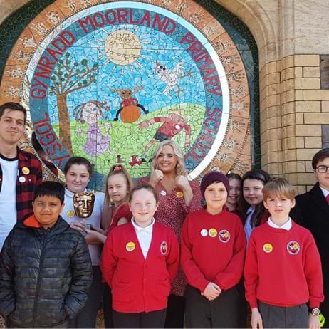 Katie Thistleton with children outside school