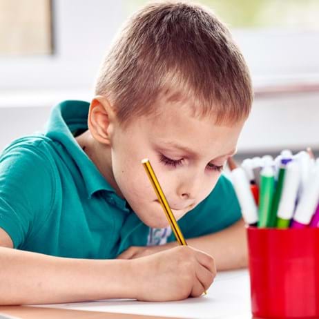 Boy drawing in school