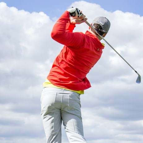 Golfter teeing off
